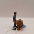 1970's man pushing 2 wheeler dolly