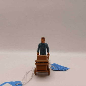 1970's man pushing 2 wheeler dolly