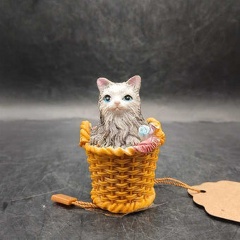 Ceramic cat snuggled in basket