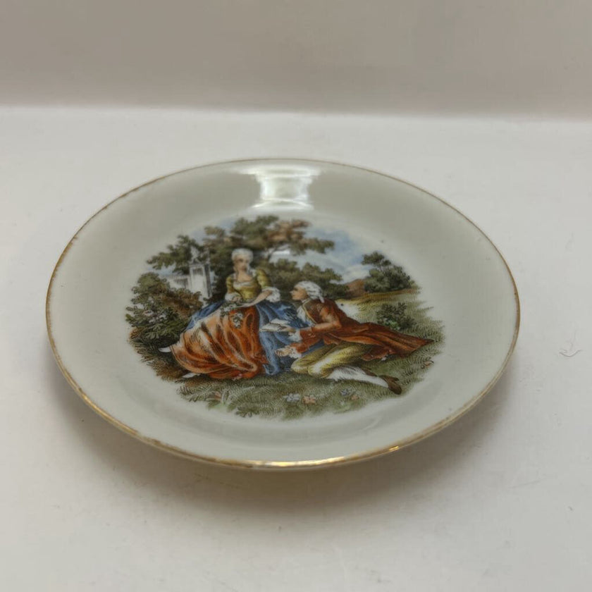 Vintage Occupied Japan porcelain demitasse cup and saucer with courting couple scene
