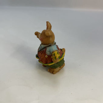 Miniature Rabbit Holding Flowers
