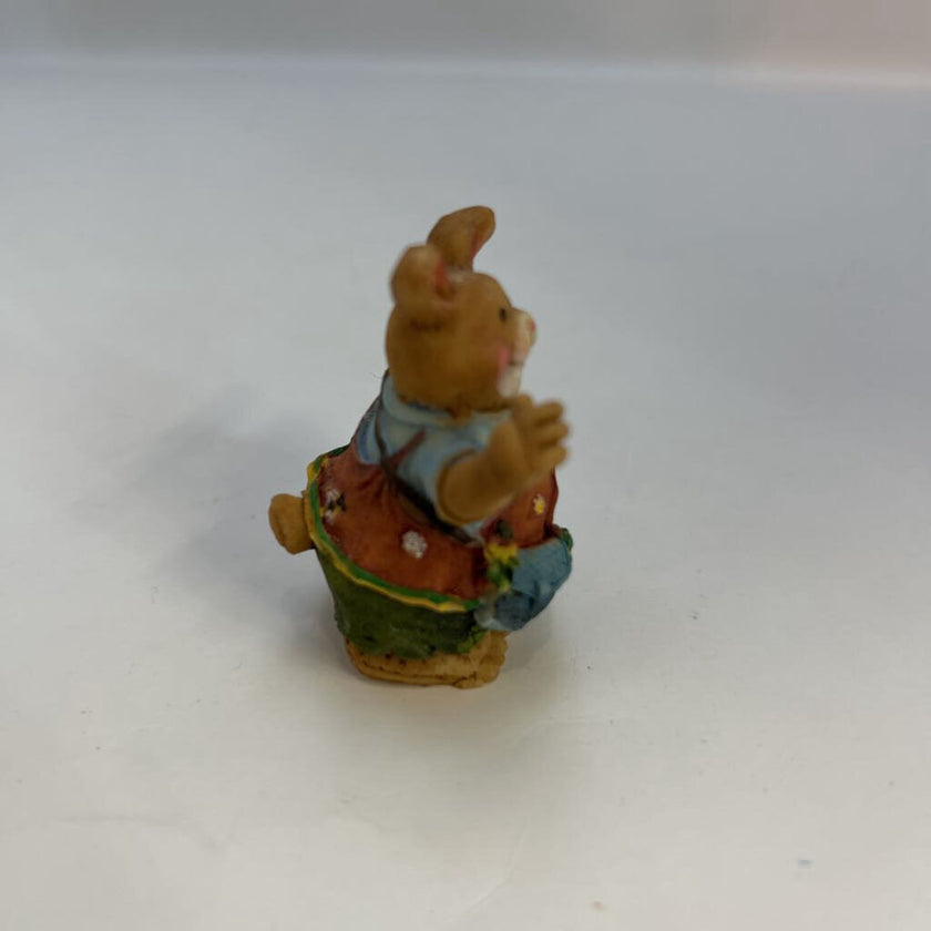 Miniature Rabbit Holding Flowers