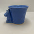 vintage blue ceramic dog planter with artificial flowers.