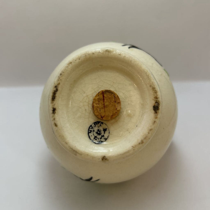Vintage hand-painted ceramic shaker with green floral design, made in Japan.