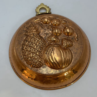 Vintage Italian copper jelly mold with embossed pineapple and fruit design.