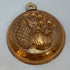 Vintage Italian copper jelly mold with embossed pineapple and fruit design.