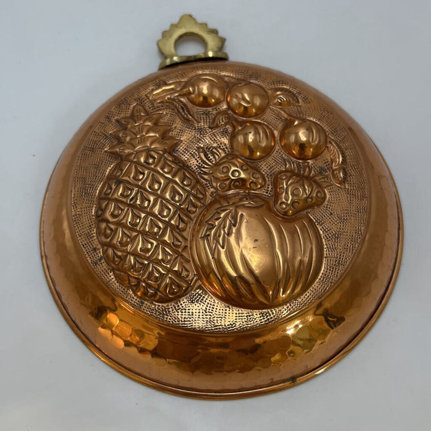 Vintage Italian copper jelly mold with embossed pineapple and fruit design.