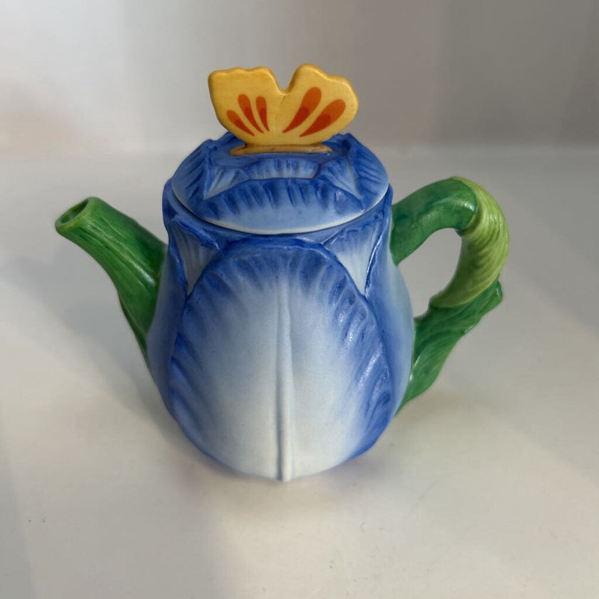 Miniature ceramic Avon teapot shaped like a blue tulip with a butterfly lid