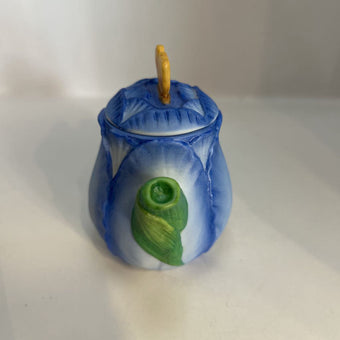 Miniature ceramic Avon teapot shaped like a blue tulip with a butterfly lid